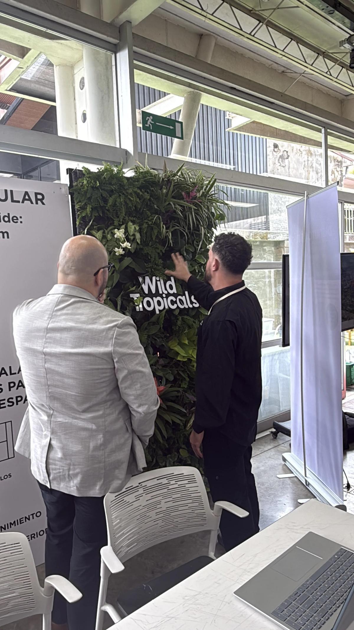 Visitors interacting with Wild Tropicals' living wall installation at CICS 2026.