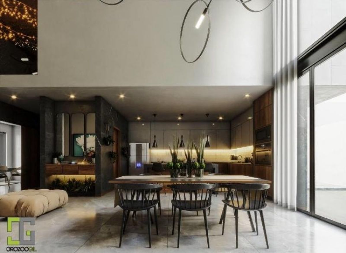 Comedor con mesa de madera, sillas negras, candelabro circular y cocina al fondo