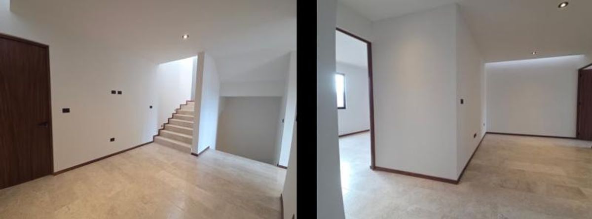 Interiores con pisos de mármol beige, muros blancos, escaleras y carpintería de madera oscura