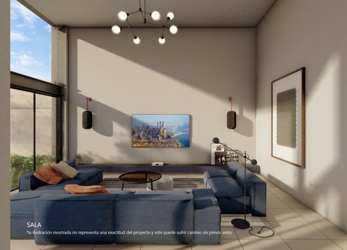Sala con sofás modulares azules, mesa de centro redonda y televisión en la pared