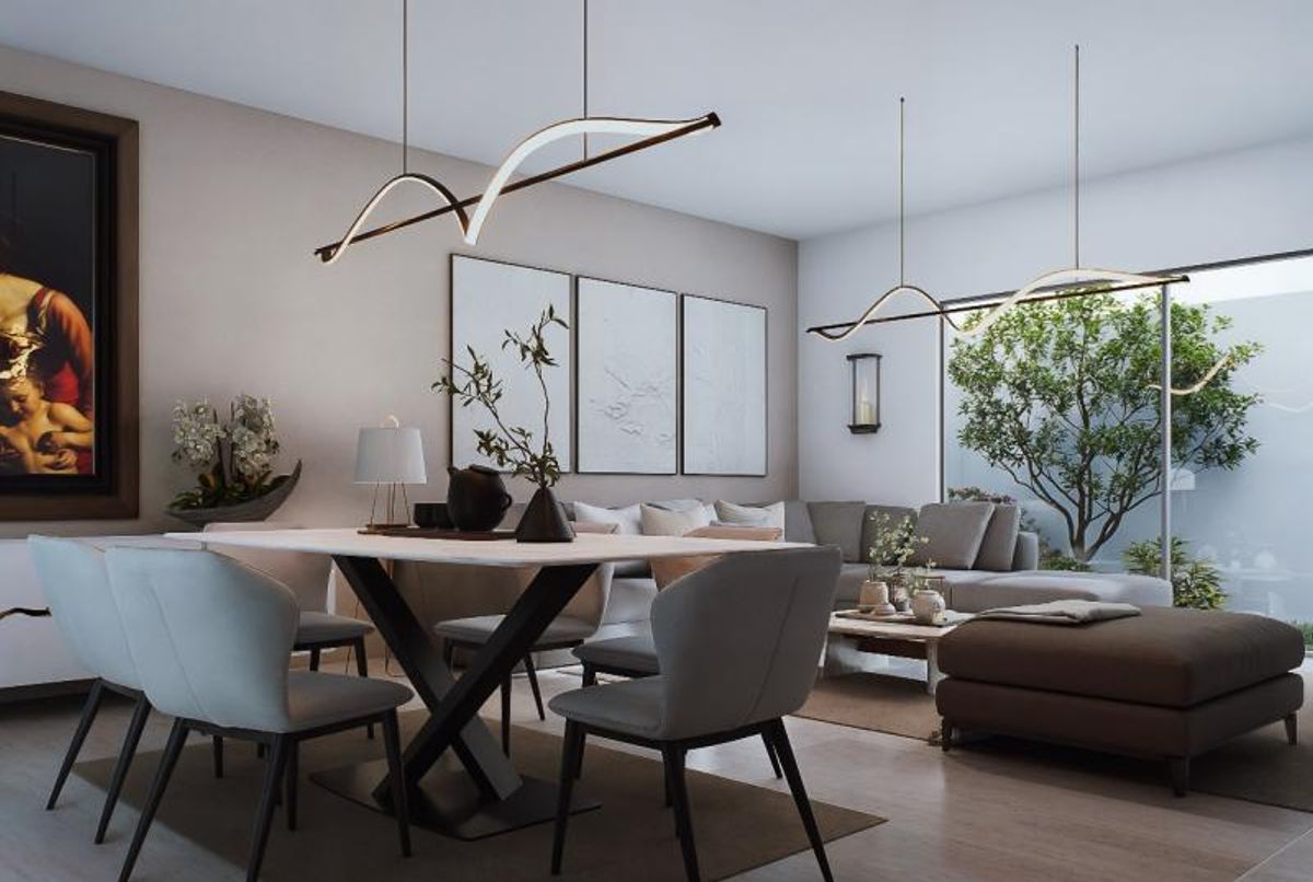 Comedor moderno con mesa clara, sillas grises, lámparas colgantes curvas y sala al fondo