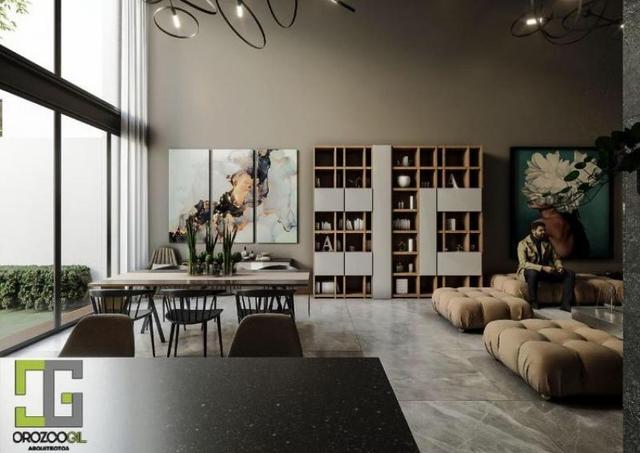 Comedor y sala con grandes ventanales, librero de madera, cuadros decorativos y sillones modulares