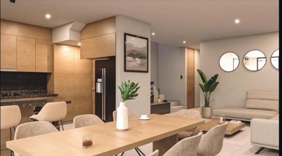 Comedor con mesa de madera, cocina integral con gabinetes de madera y sala contigua