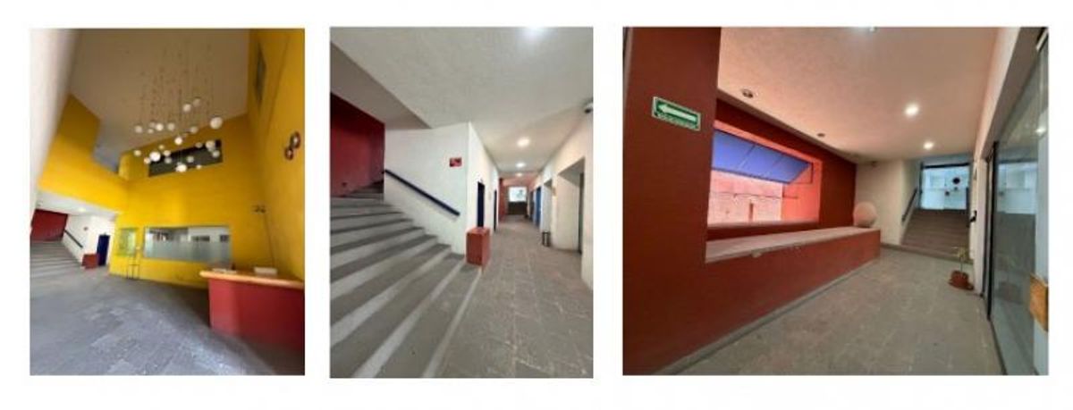 Vestíbulo y pasillos comerciales con escaleras, piso de piedra y muros amarillo y terracota