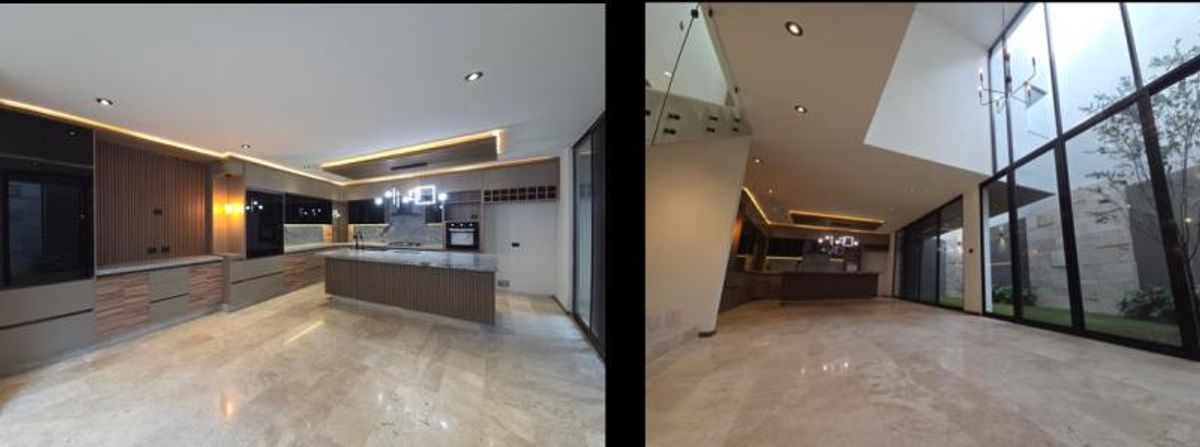 Cocina integral con isla, iluminación led y estancia con ventanales de piso a techo