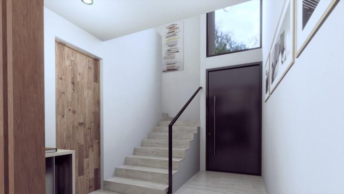 Vestíbulo con escalera de piedra, barandal de metal negro y puerta principal oscura