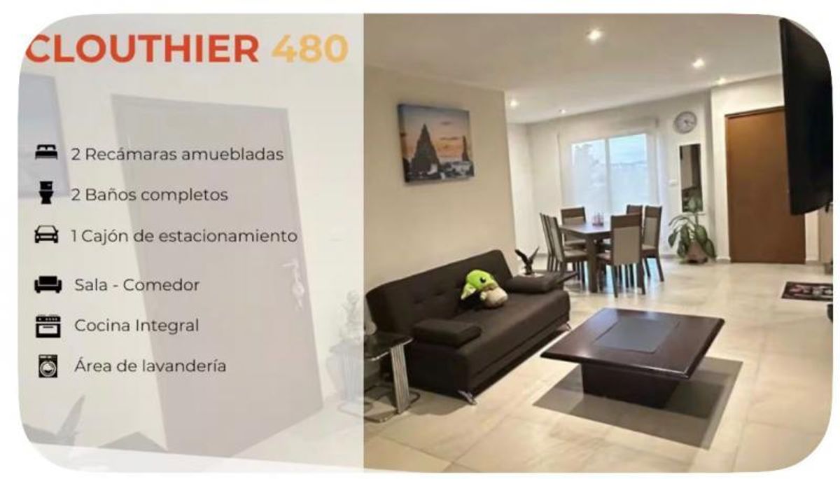 Sala amueblada con sofá oscuro y mesa de centro junto a comedor de madera