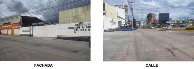 Fachada de local comercial con bardas blancas y vista a la avenida de concreto