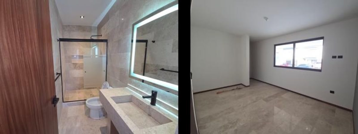 Baño moderno con espejo retroiluminado y recámara vacía con pisos de mármol y ventana