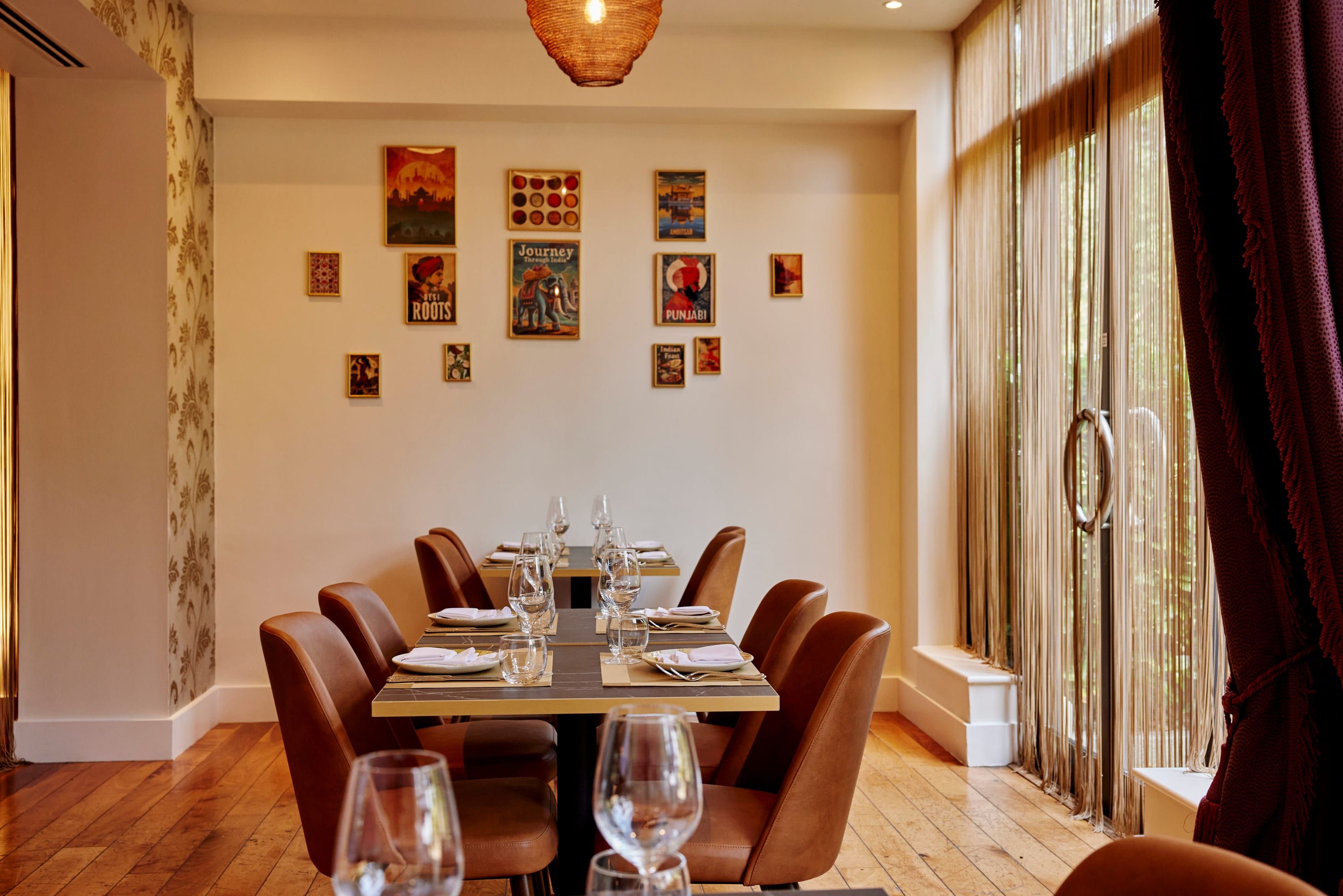 The private dining room laid for a group, with a long table and warm pendant lighting