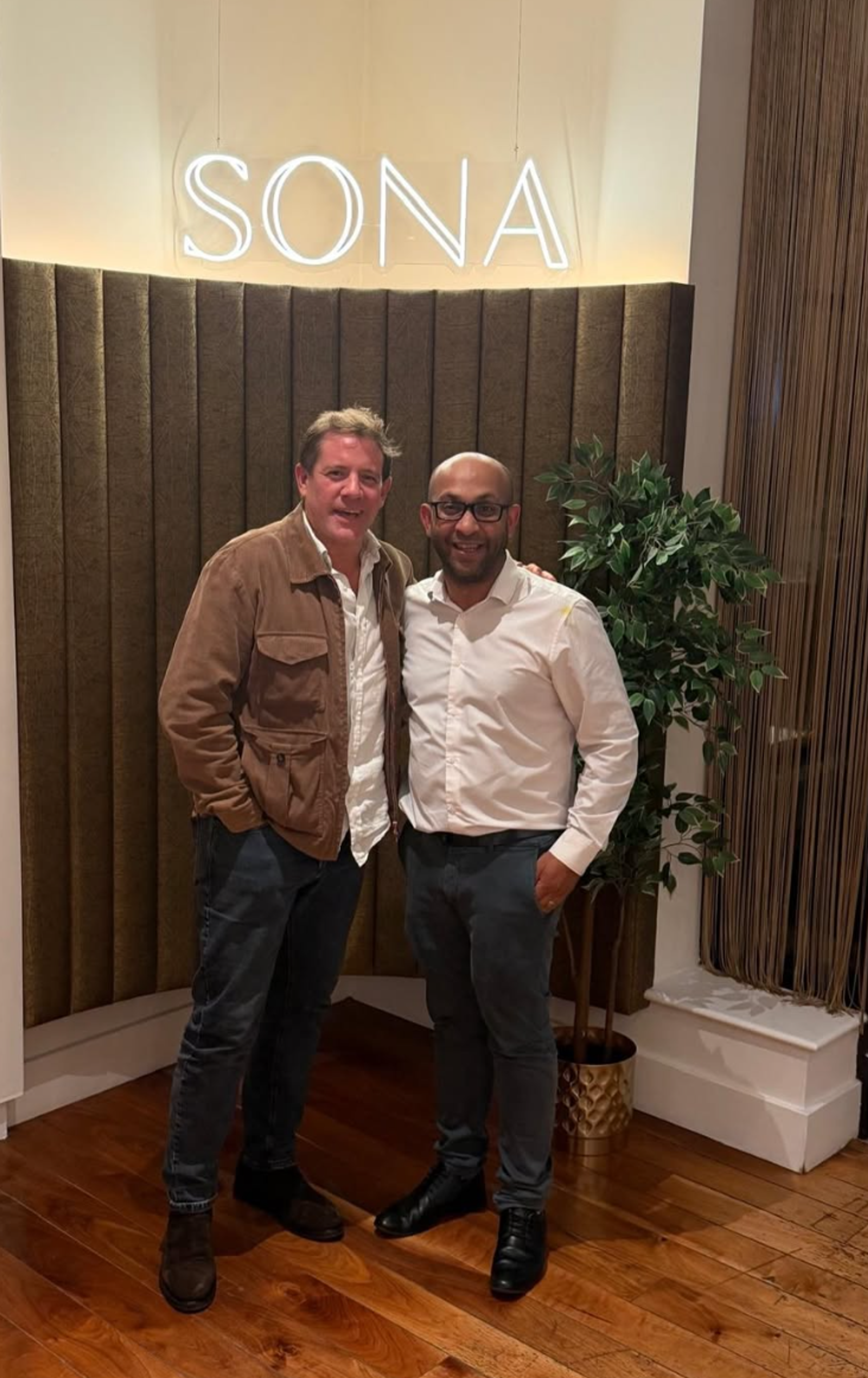 Celebrity chef Matt Tebbutt with Faisal Rahman of SONA beneath the illuminated SONA sign