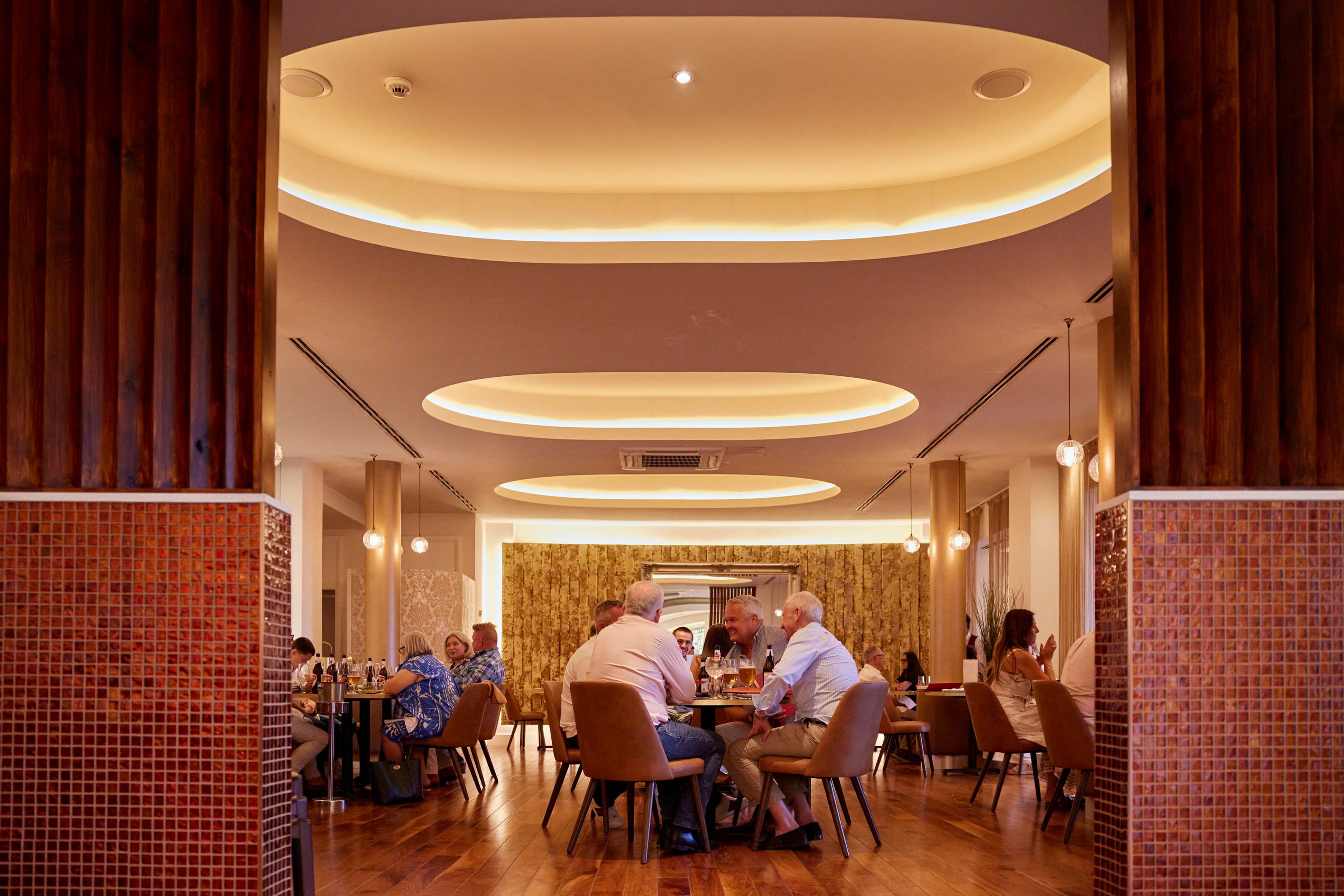 Guests dining in the SONA restaurant, seen between tiled columns