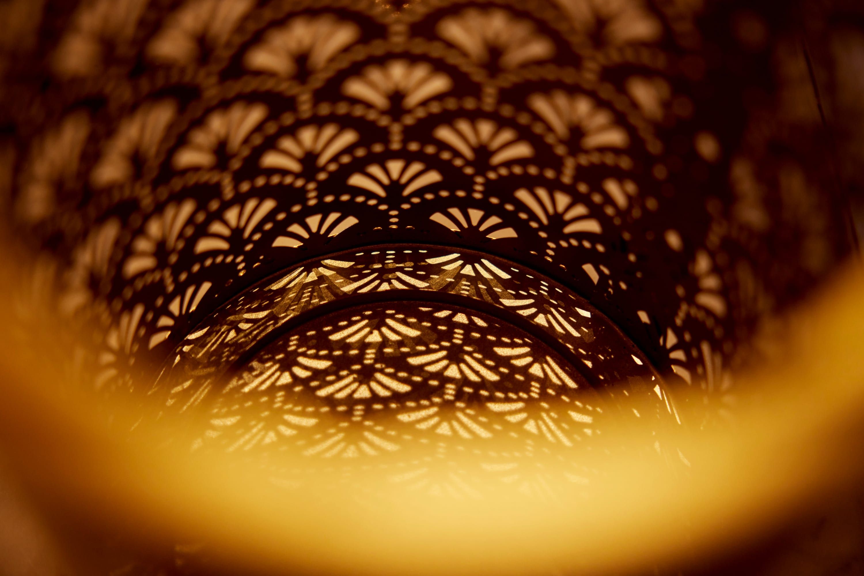 Warm light through a brass lattice lamp