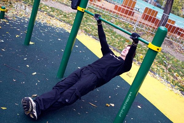 Inverted bodyweight rows. Playgrounds have many creative opportunities for muscle growth.