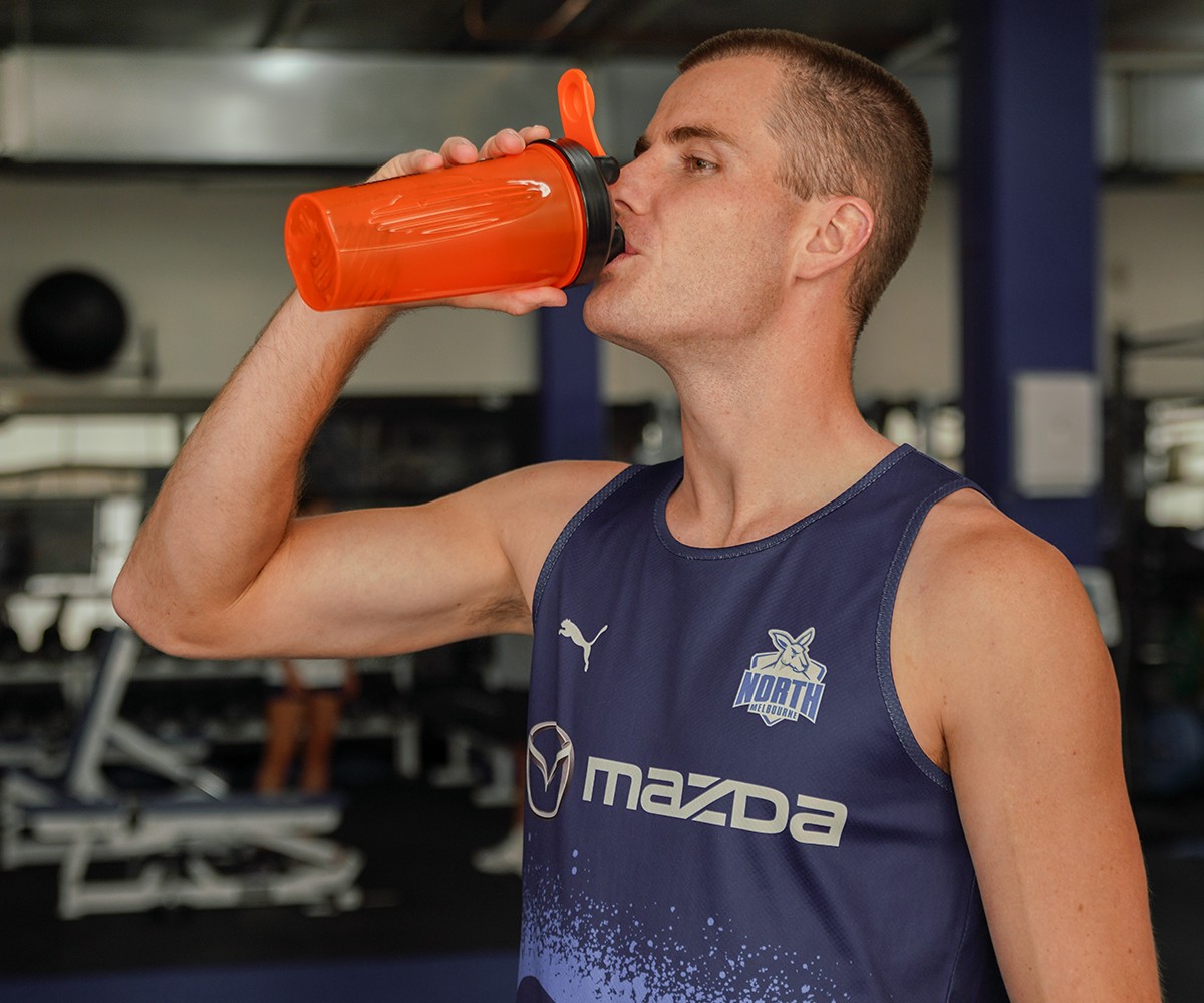 Bulk Nutrients x North Melbourne Football Club Partnership Player drinking from Bulk Shaker
