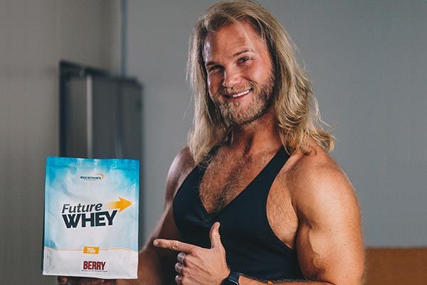 Bulk Ambassador Andrew Lutomski holding a 750g pouch of Bulk Nutrient's vegan-friendly Future Whey Berry flavour free-amino protein. Future Whey is a refreshing way to take protein... Future Whey is now 100% plant based free form amino acids and available in three great flavours (Berry, Cola and Lemonade!). Available in 750g pouches.