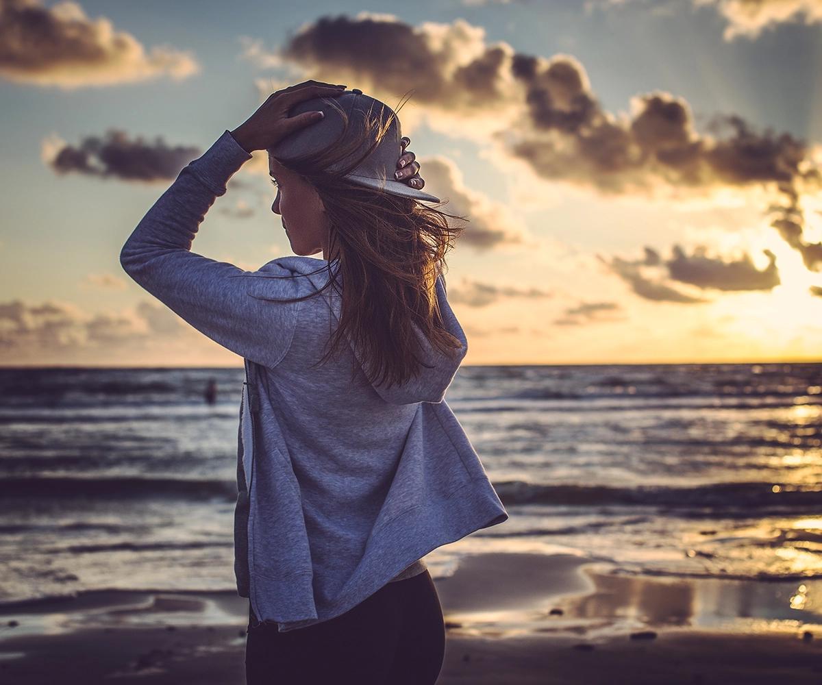 woman at the beach with sunset sky background