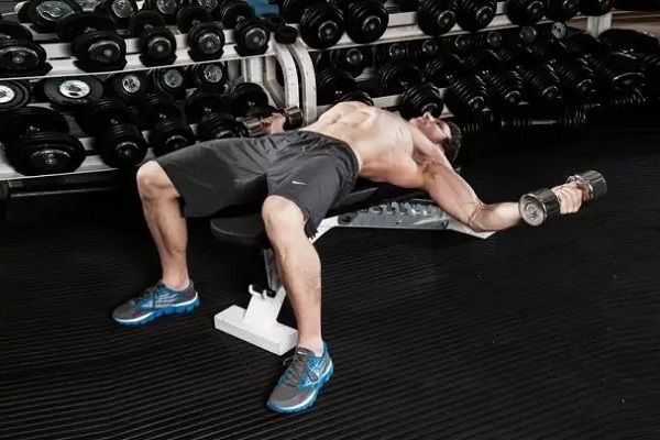 Holding the stretch at the bottom of a dumbbell fly allows for a serious muscle stretch.