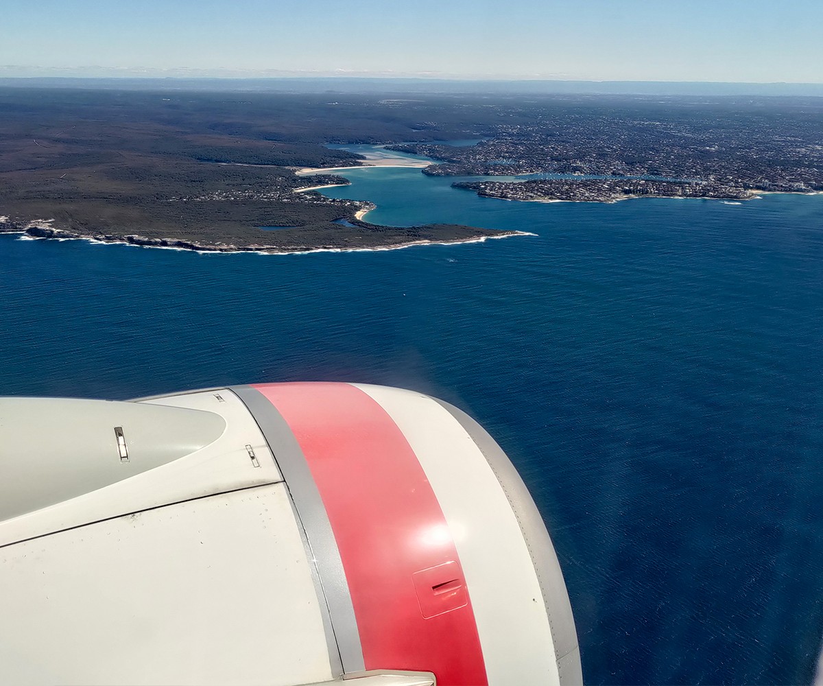 Plane flying over water and land