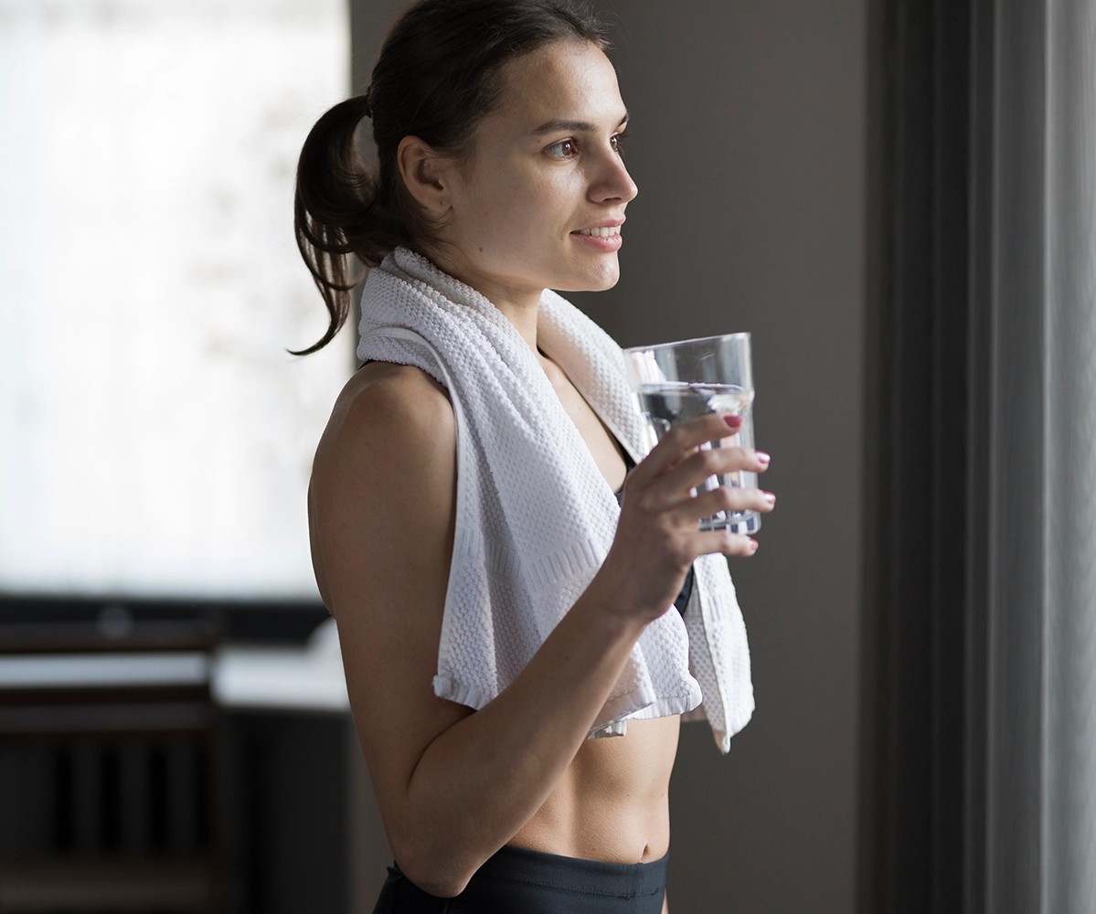 Women drinking a cup of lemon water