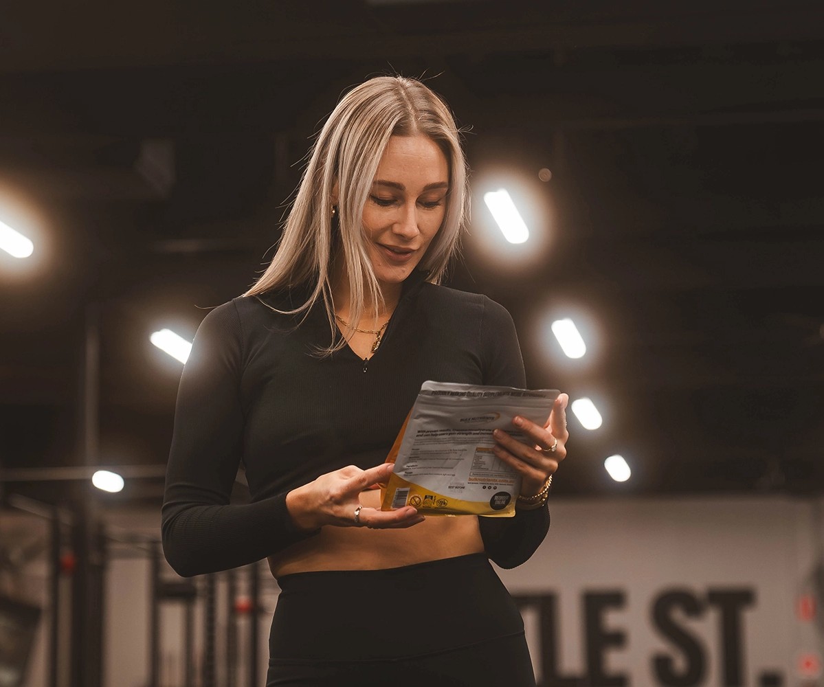 Bulk Nutrients Ambassador Chelsea Reid looking at a product