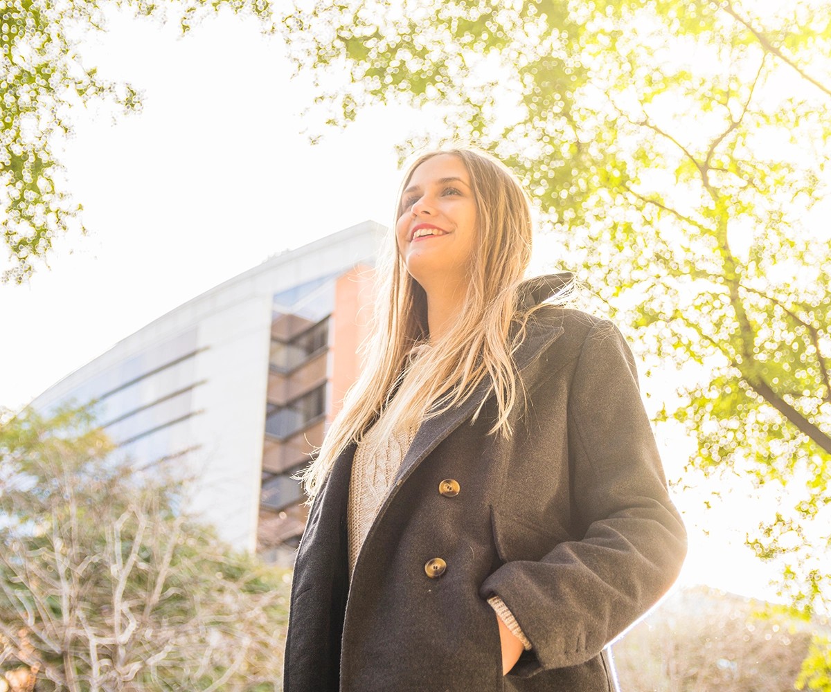 female smiling in the autumn with tree branches
