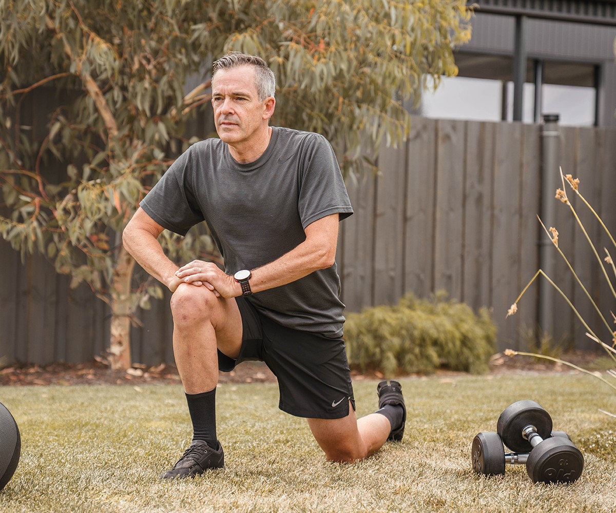 Man stretching in the back yard