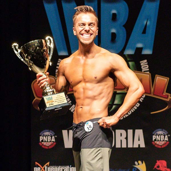 Bulk Ambassador Trent Baynes with a smile from ear to ear on stage has he wins 1st place at the INCA VIC men's fitness division.
