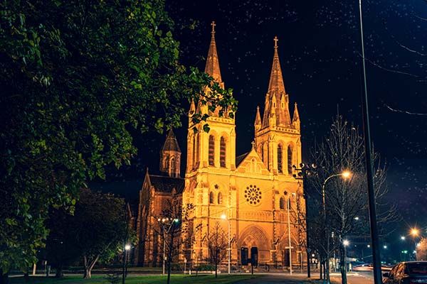 An old, gothic church lit up with lights at night in Adelaide, South Australia.