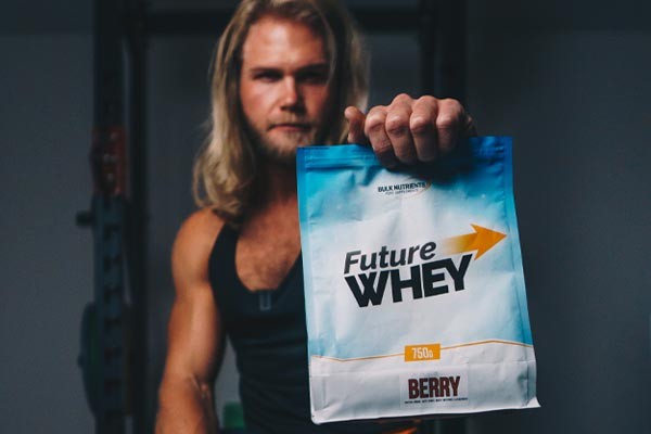 Bulk Ambassador Andy Leigh holding a 750g pouch of Bulk Nutrient's vegan-friendly Future Whey Berry flavour free-amino protein. Future Whey is a refreshing way to take protein... Future Whey is now 100% plant based free form amino acids and available in three great flavours (Berry, Cola and Lemonade!). Available in 750g pouches.