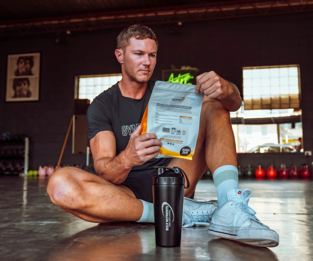 Ryan Van Duiven looking at a Bulk Nutrients Bag with Black Stainless Steel Shaker