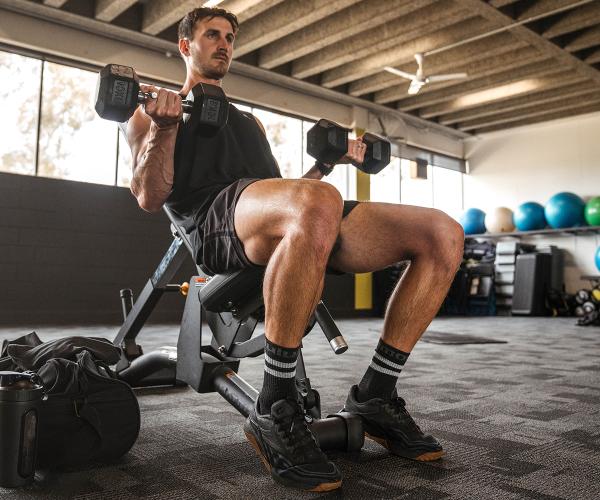 Man lifting dumbbells in the gym
