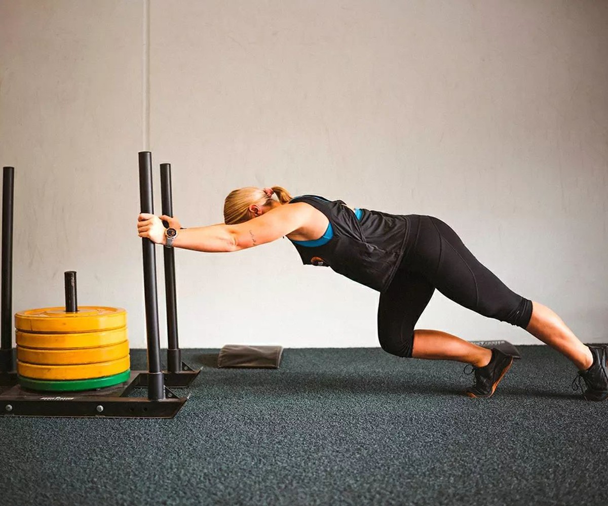 Bulk Nutrients Ambassador Louise Calvert in the gym pushing a weight sled