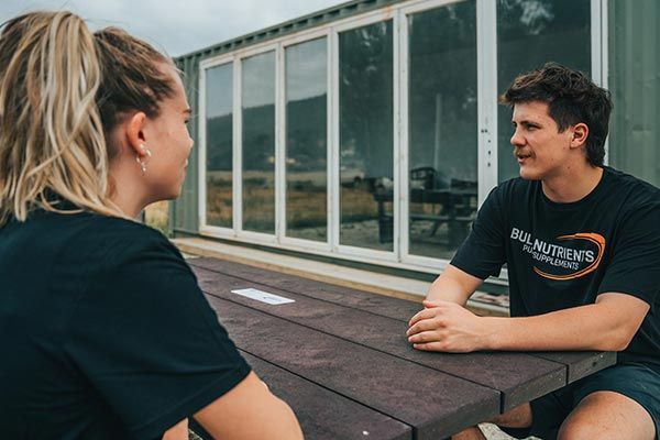 Bulk Nutrients staff sitting at the RedCycle table