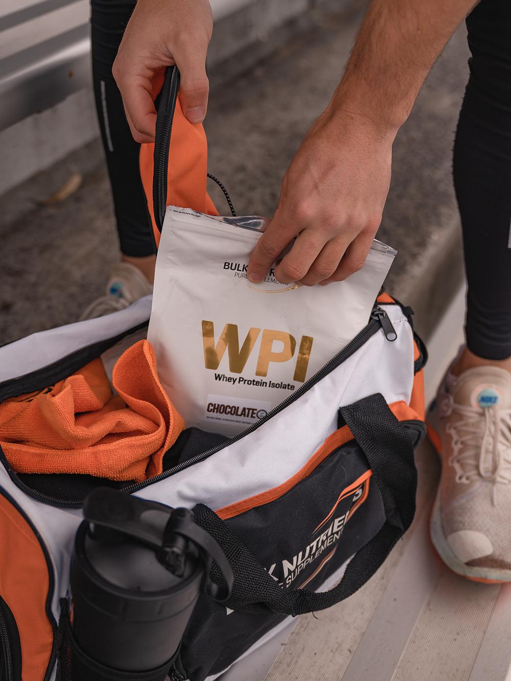 Bulk Nutrients Whey Protein Isolate getting put into a gym bag