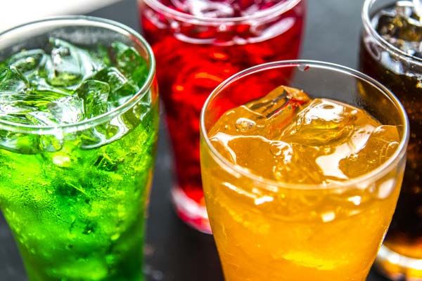 A tray of brightly coloured fizzy drinks.