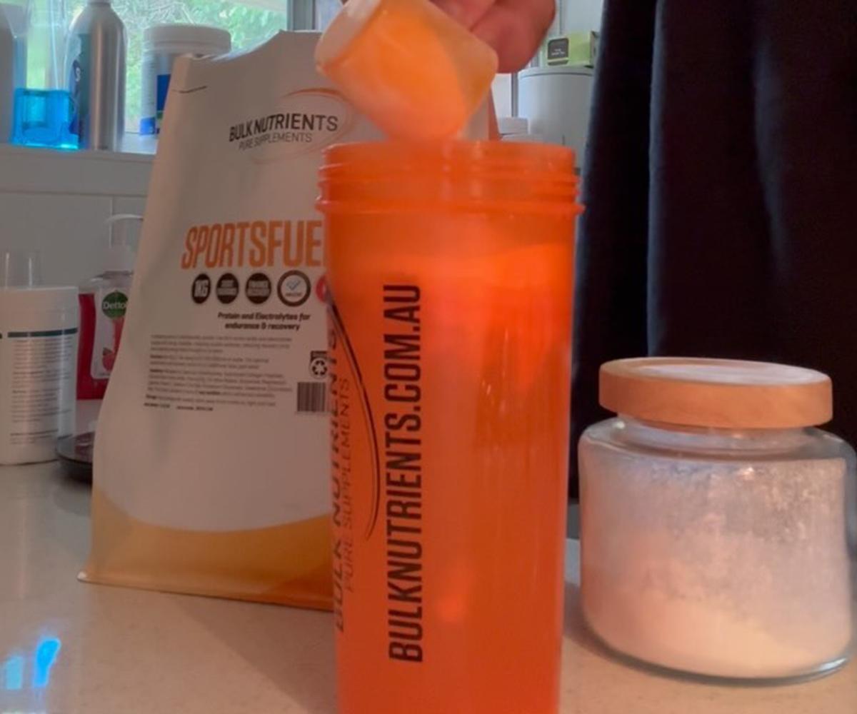 Bulk Nutrients SportsFuel 101 scooped into a shaker.