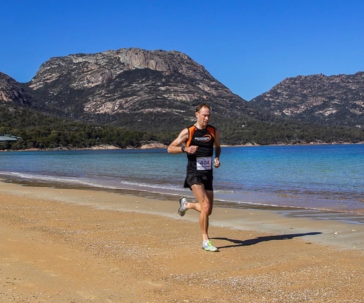 Sponsored Bulk Athlete Chris Sullivan running the Freycinet beach in Tasmania