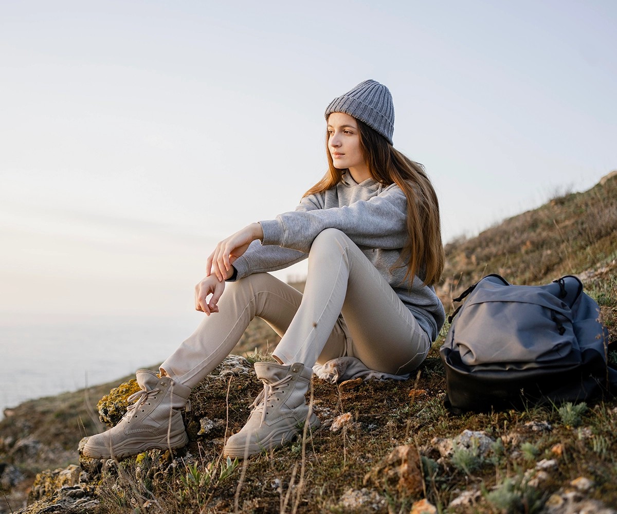 Woman sitting on the side of a hill