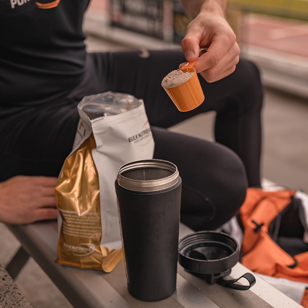 Bulk Nutrients Whey Protein Isolate being scooped into a shaker