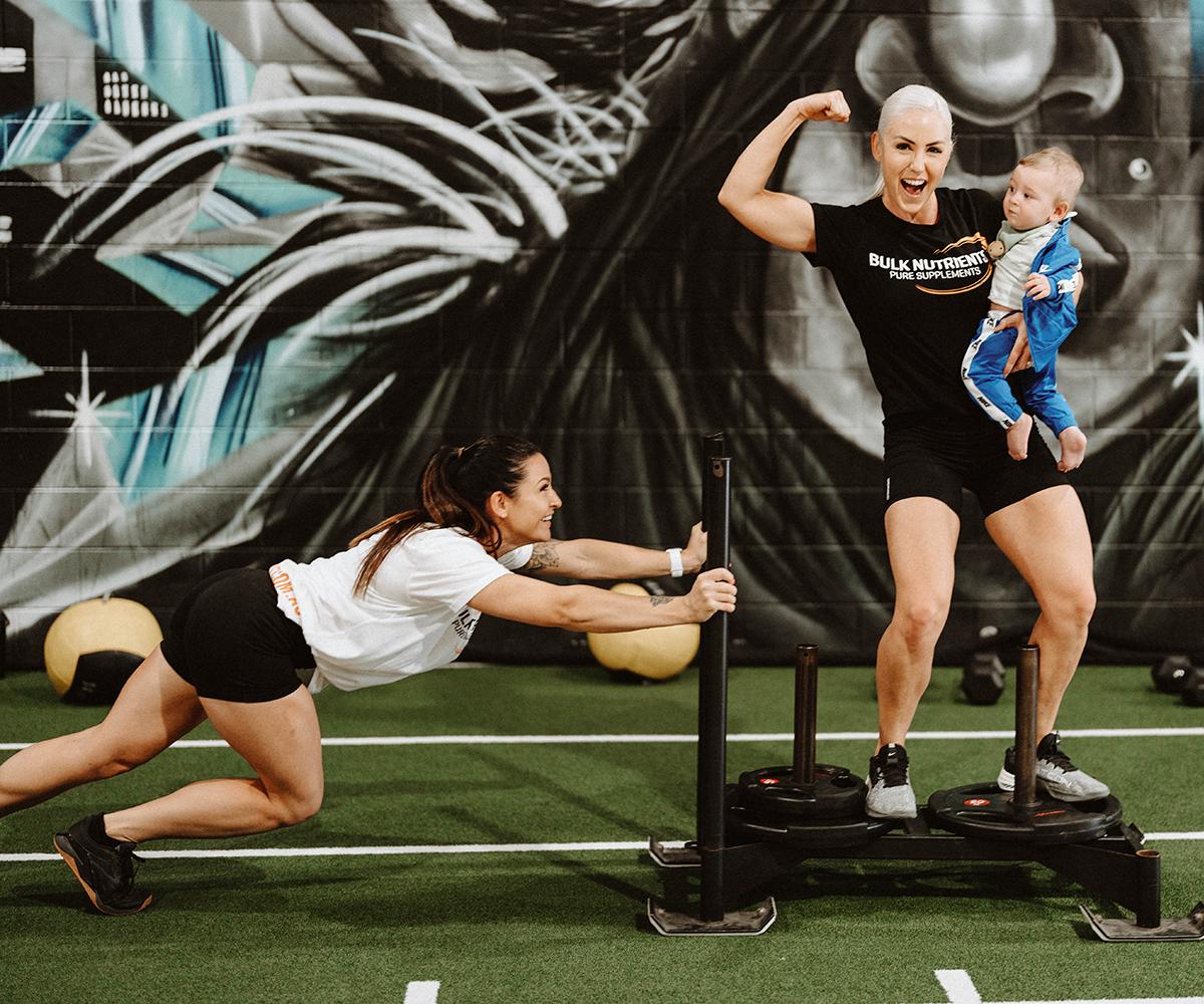 Bulk Nutrients Ambassadors Tammie Sarkozy and Tarran Lee in the gym with sled