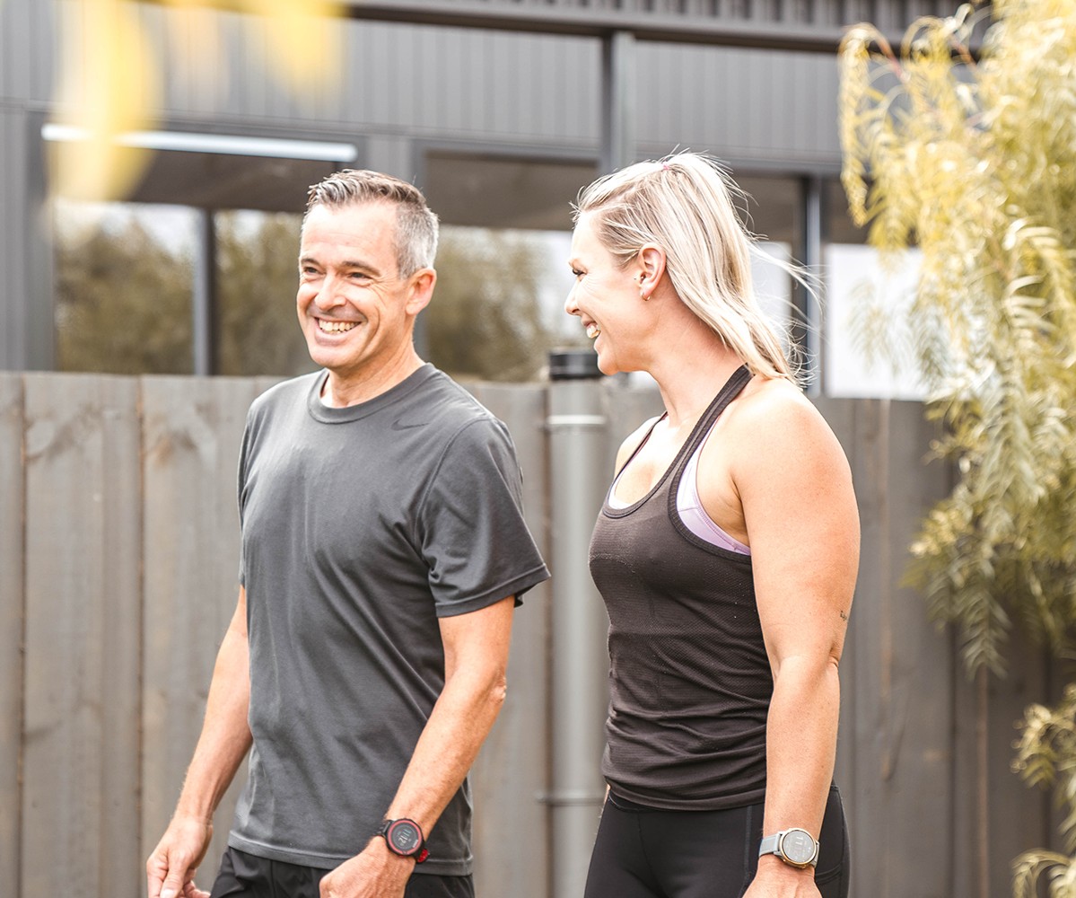 Two people walking outside