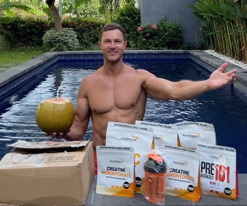 A muscular man experiencing inflammation and discomfort in his elbow.