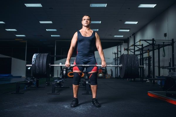 Gym-goer lifting heavy weights