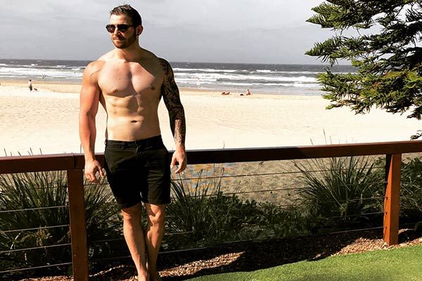 Sam Brereton posing at the beach.