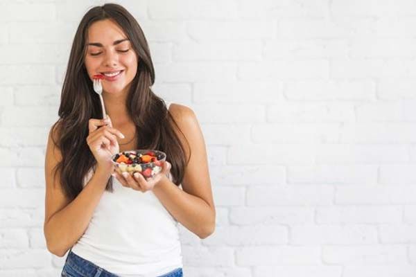 Eating a bowl of fruit salad