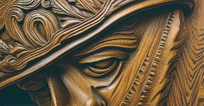 A close-up of a finely carved wooden statue with detailed textures and warm lighting, set against a blurred background.