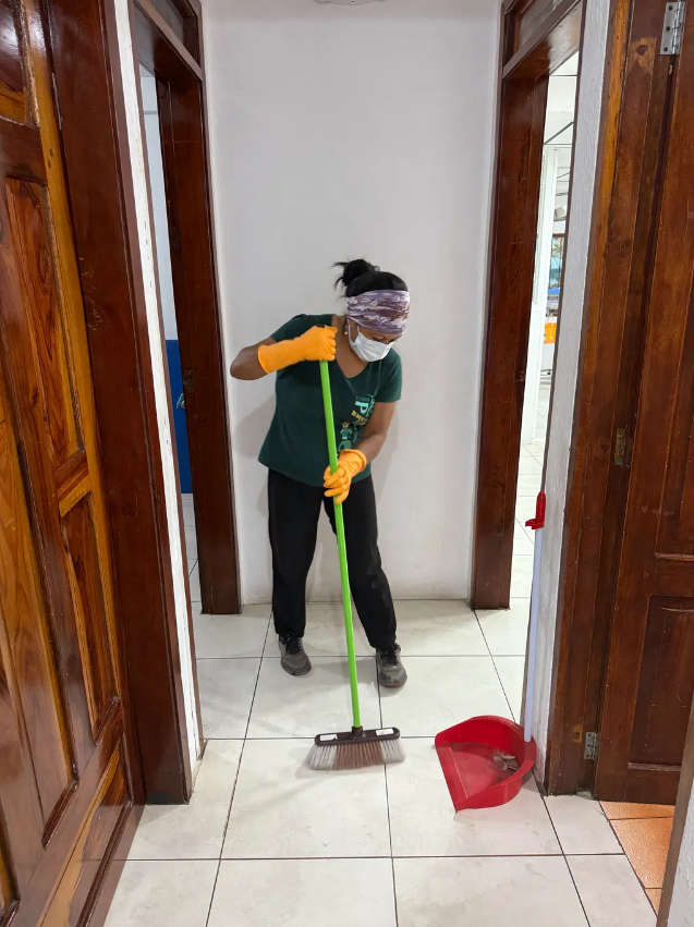 member of staff sweeping