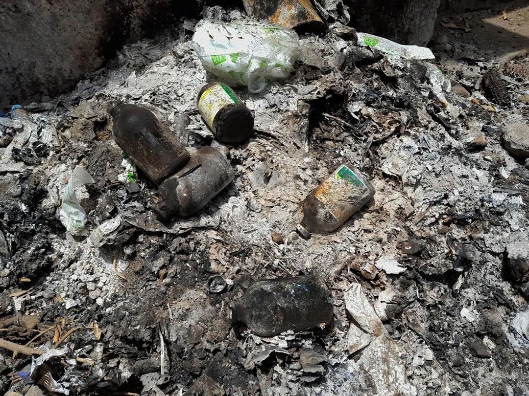 Figure 3 These veterinary medicine bottles and plastics have been burned in the open; this contaminates the environment with toxic fumes and glass
