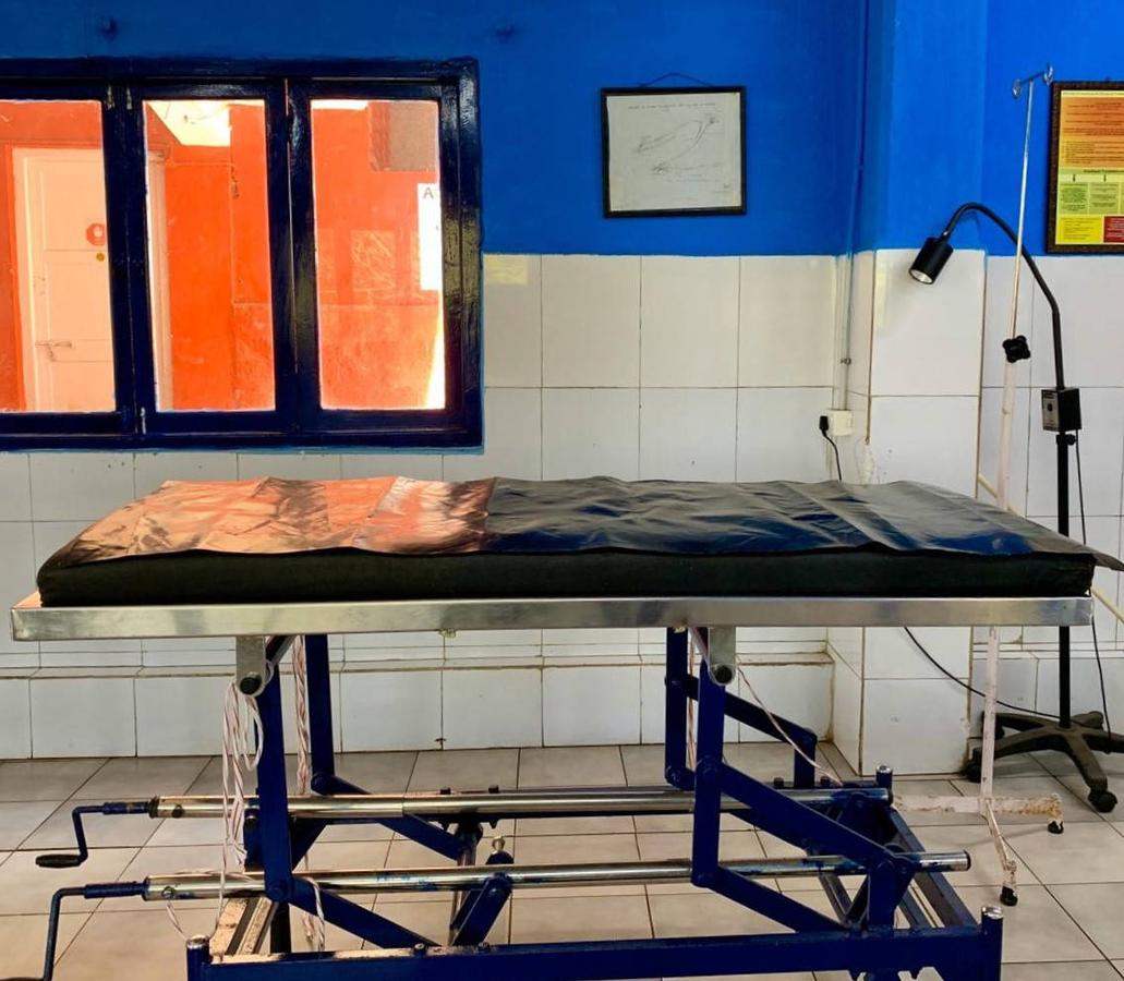 Figure 2 - A stainless steel operating table with washable theatre mattress and tiled wall and floor surfaces, all facilitating easy cleaning.